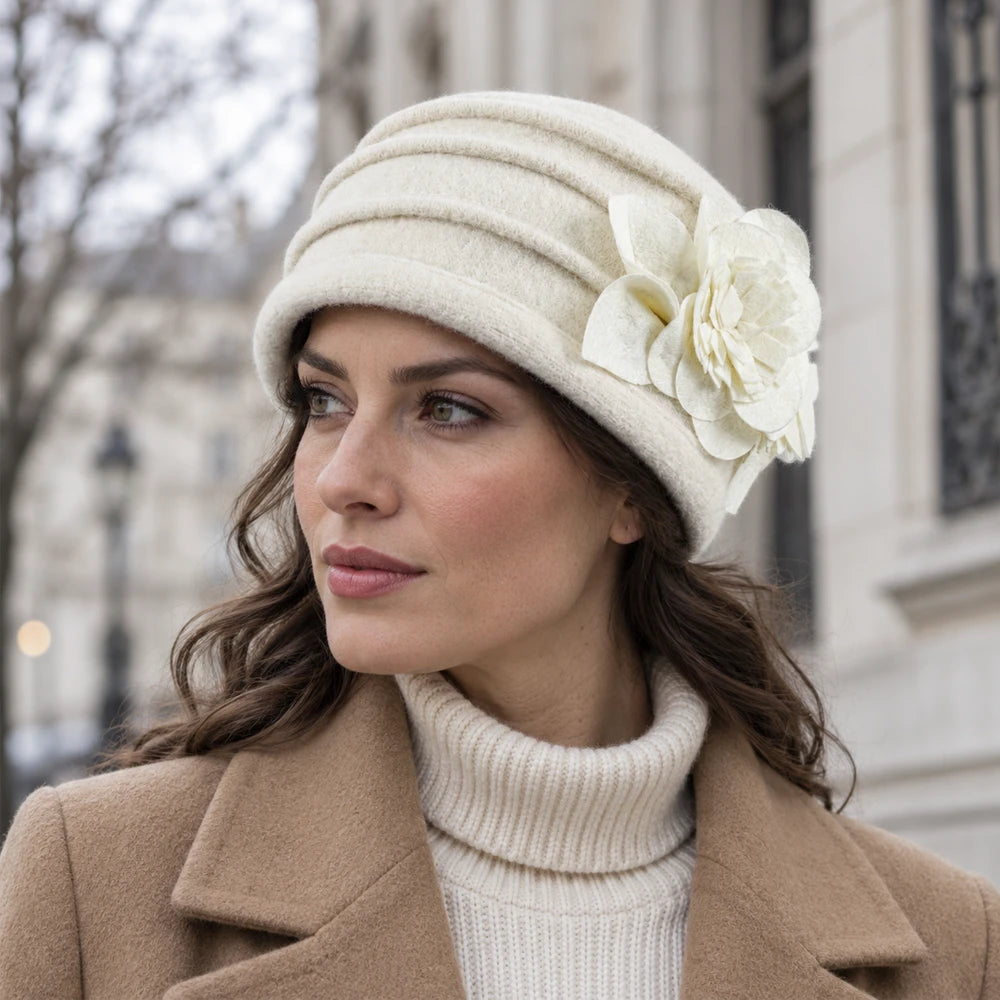 Woman wearing a cream brimless wool cloche-style hat with a winter coat