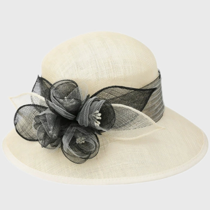 Timeless cream cloche sinamay hat with a black floral accent, great for formal occasions, tea parties, and church services.