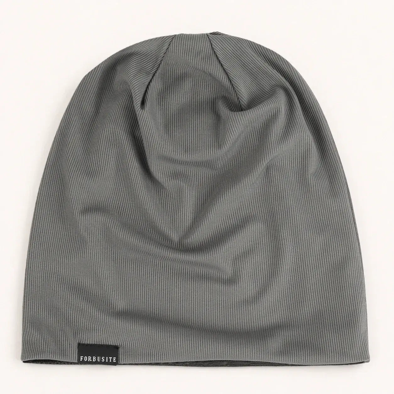 Dark gray lightweight slouchy beanie hat showing the long crown and natural fabric folds