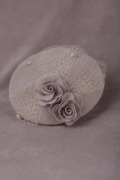 Vintage dusty pink pillbox fascinator hat with roses and netting