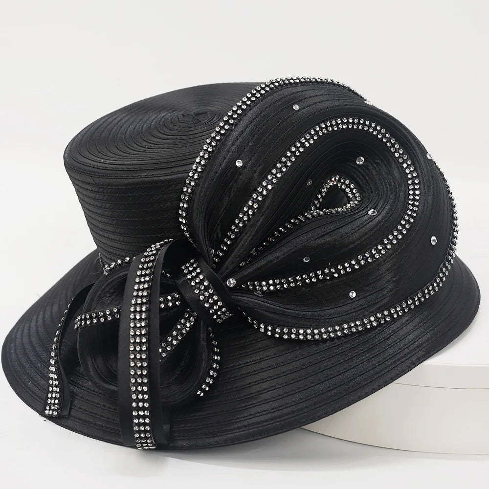 Side angle of an elegant women’s black church hat with sculptural satin bow and crystal embellishments.
