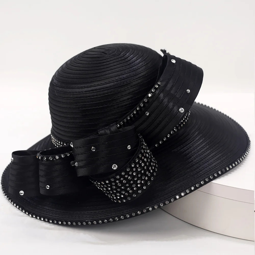 Side angle of a gold church hat with crystal bow design, perfect for events.