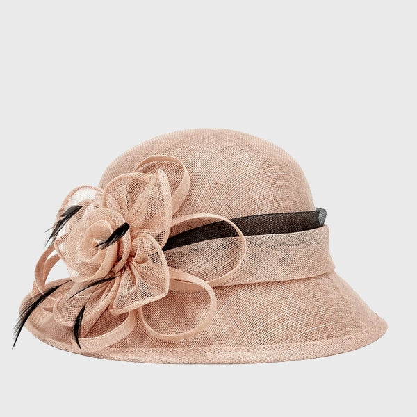 elegant pink cloche sinamay hat featuring a large flower and feather detail, perfect for weddings, church events, and special occasions.