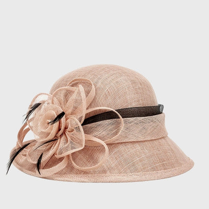 elegant pink cloche sinamay hat featuring a large flower and feather detail, perfect for weddings, church events, and special occasions.