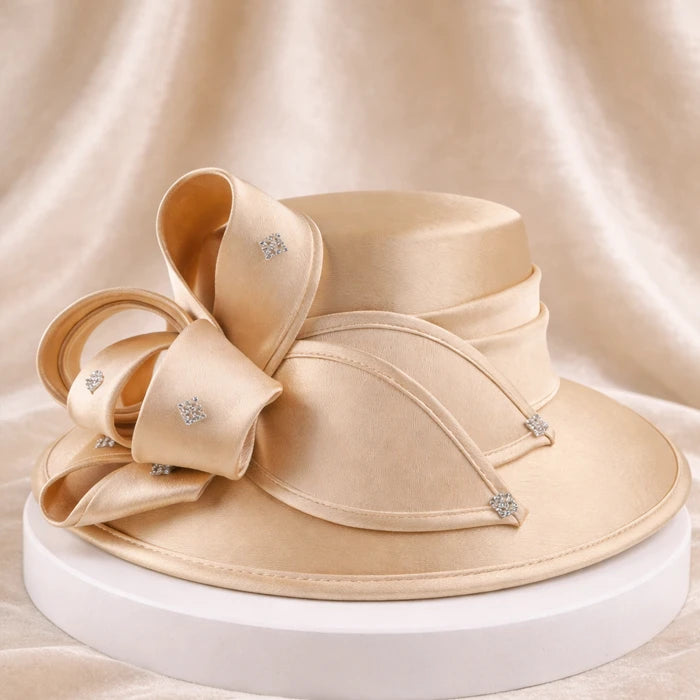 Elegant beige satin church hat with crystal details, perfect for weddings and formal events.