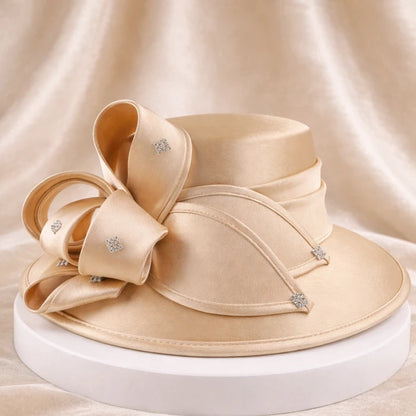 Elegant beige satin church hat with crystal details, perfect for weddings and formal events.