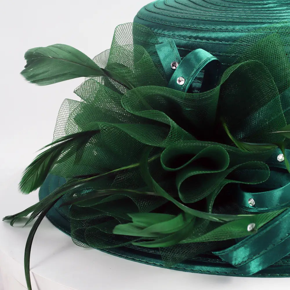 Close-up of Emerald Green Church Hat with Feather and Ribbon Accents – FORBUSITE