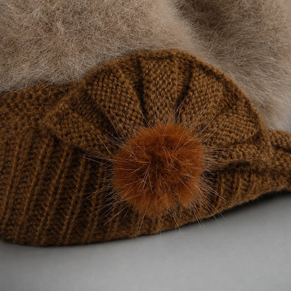 Fixed knit side detail with angora pom accent on women’s visor beanie
