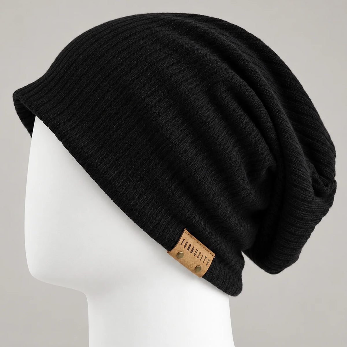 Black knit slouchy beanie with leather side detail and relaxed draped back
