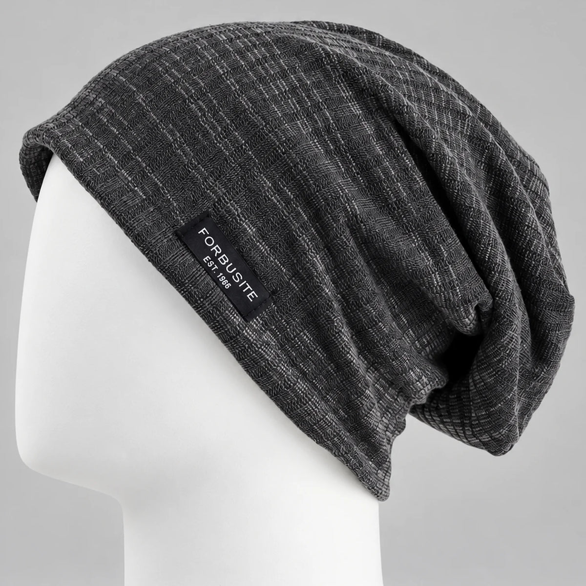 Charcoal patterned slouchy beanie with soft draped back on a mannequin head
