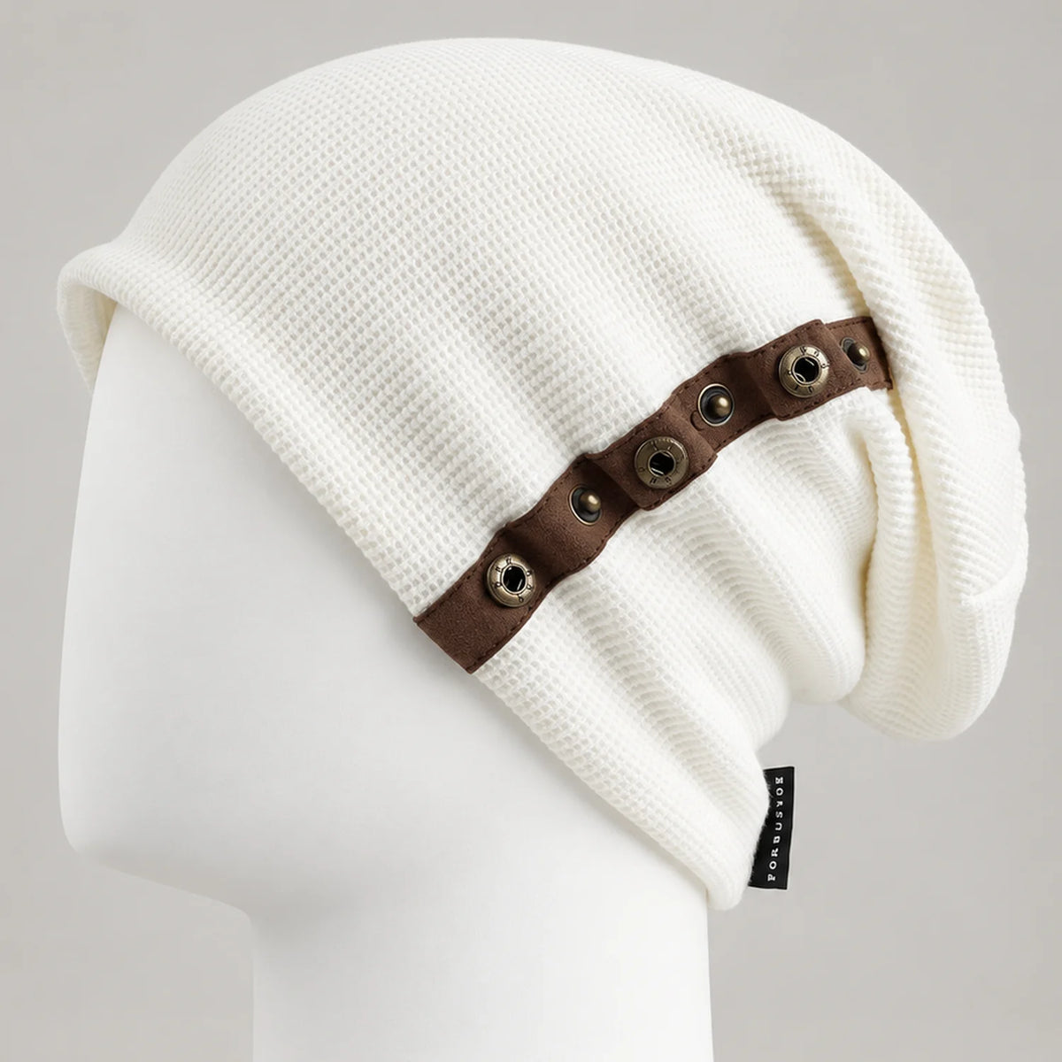 White textured slouchy beanie with brown metal-trim side detail