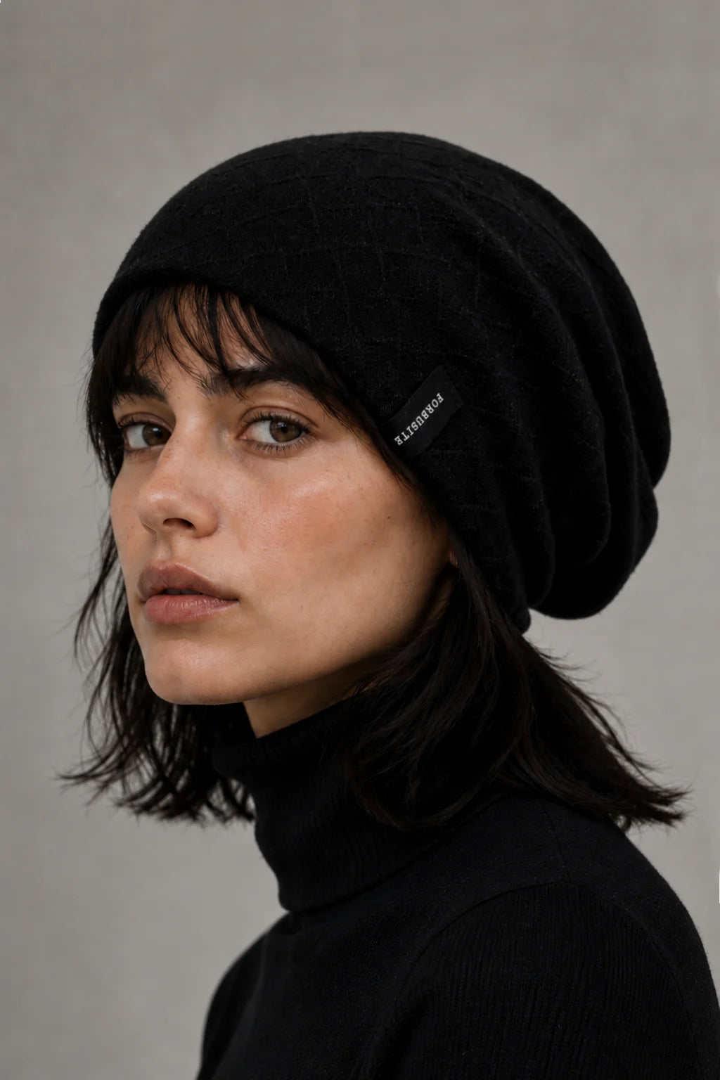 FORBUSITE black slouchy beanie with smooth lining and uncuffed fit on female model