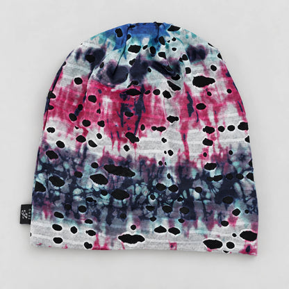 Flat front view of the blue and pink B077 beanie with white areas and black mesh visible through the cutouts.