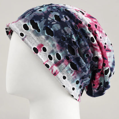Blue, pink and white tie-dye B077 slouchy beanie on a white mannequin, showing the cutout pattern and back drape.