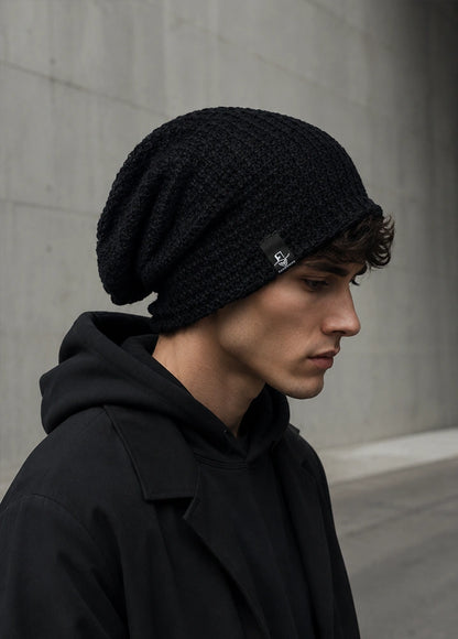 Black oversized slouchy beanie for men with long relaxed fit, textured knit design and urban streetwear look