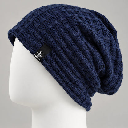 Navy knit slouchy beanie with textured openwork pattern on a mannequin head