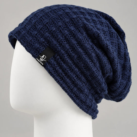 Navy knit slouchy beanie with textured openwork pattern on a mannequin head