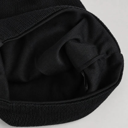Interior of the black B318 beanie showing the dark fabric lining and stitched opening.