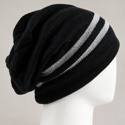 Close side view of the black beanie showing two white stripes, knit texture, and back folds.