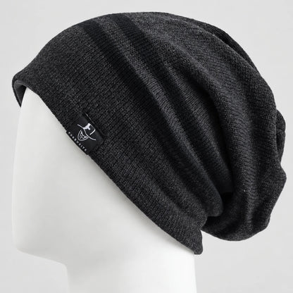Charcoal gray slouchy beanie with two dark stripes on a white mannequin, side view.