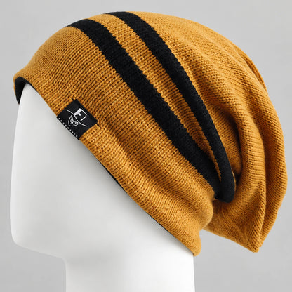 Golden yellow slouchy beanie with two black stripes on a white mannequin, side view.