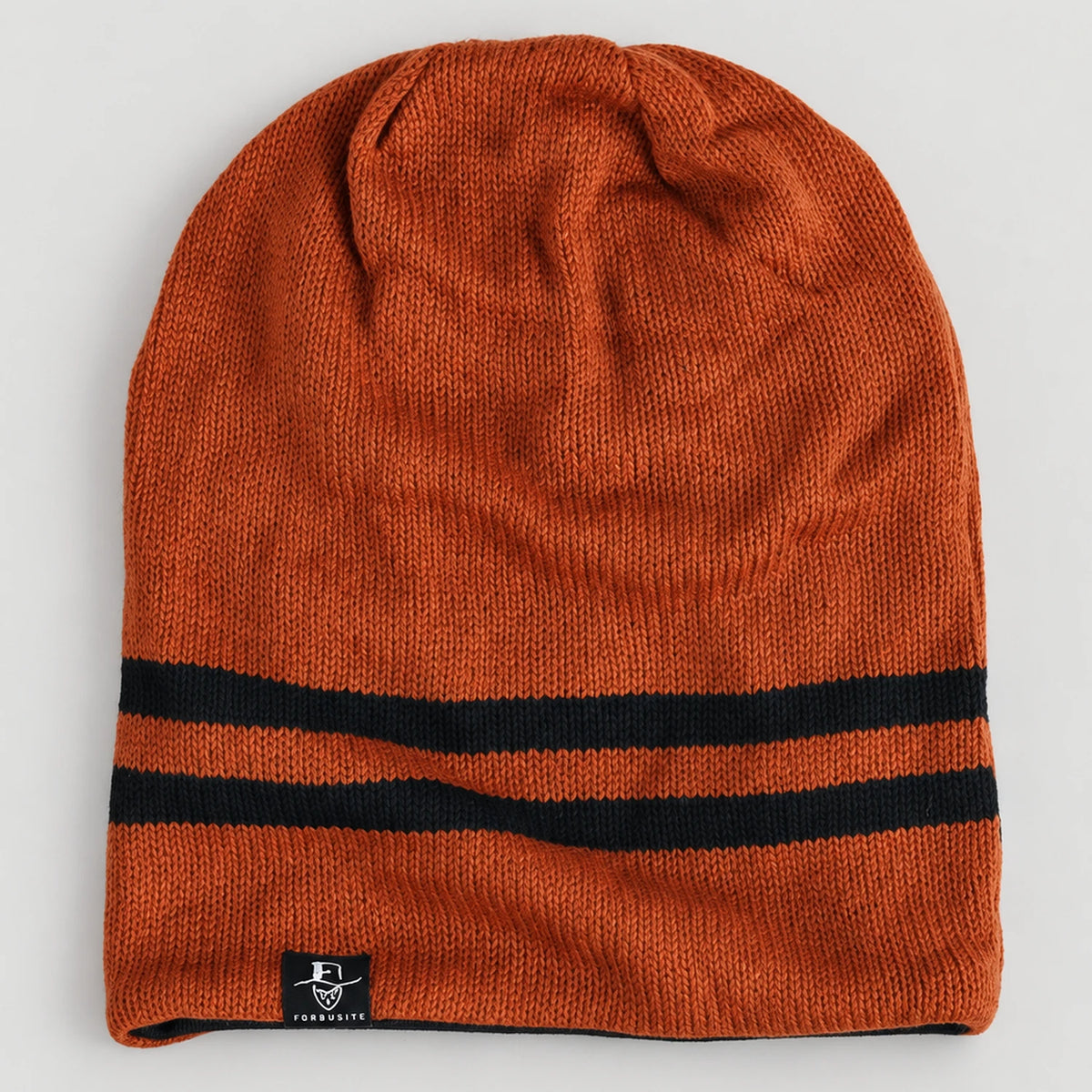 Rust orange B318 beanie laid flat, showing two black stripes near the opening.