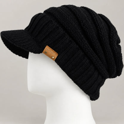 Black knit visor beanie with short brim and chunky ribbed crown on a white mannequin head