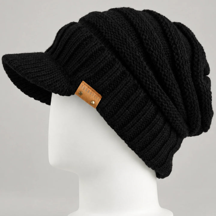 Black knit visor beanie with short brim and chunky ribbed crown on a white mannequin head