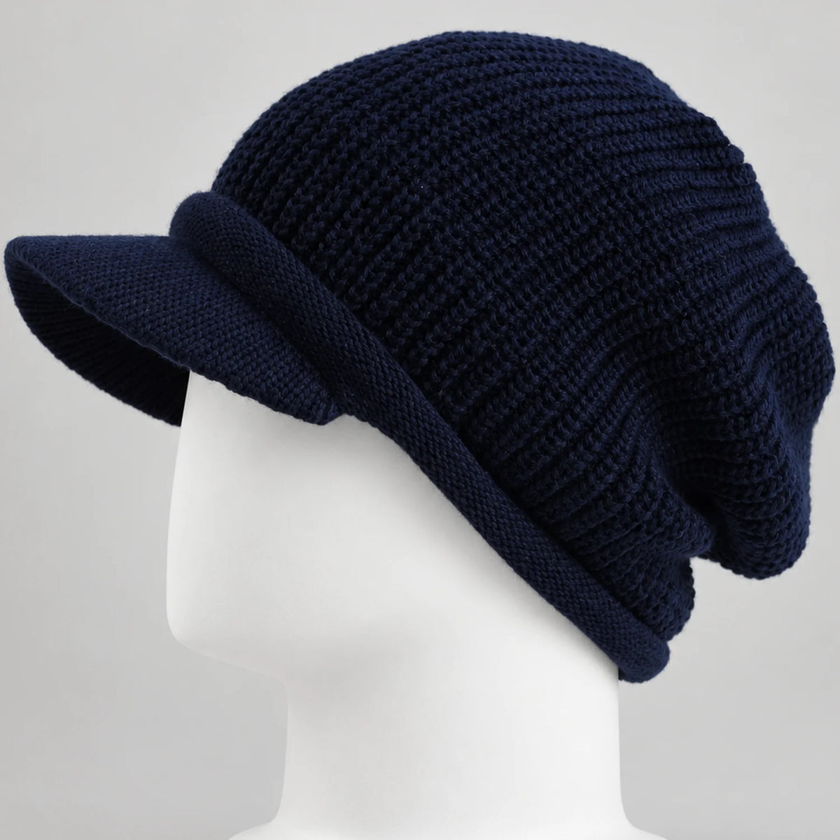 Navy knit visor beanie with short brim and textured crown on a white mannequin head
