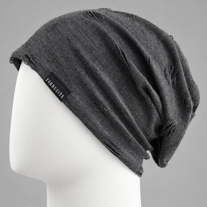 Black distressed slouchy beanie with cutout details and relaxed oversized fit