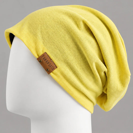 Yellow lightweight slouchy beanie with leather side detail and relaxed fit