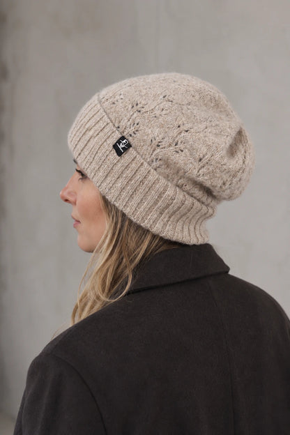 Side view of woman wearing FORBUSITE B5039 oatmeal fuzzy knit beanie with relaxed crown and wide cuff