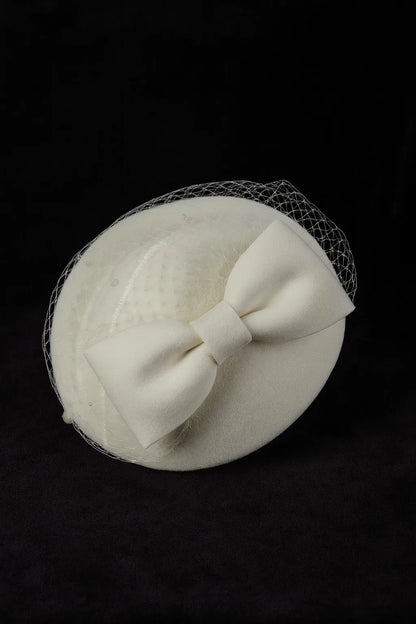 Cream church hat with birdcage veil and vintage style felt bow