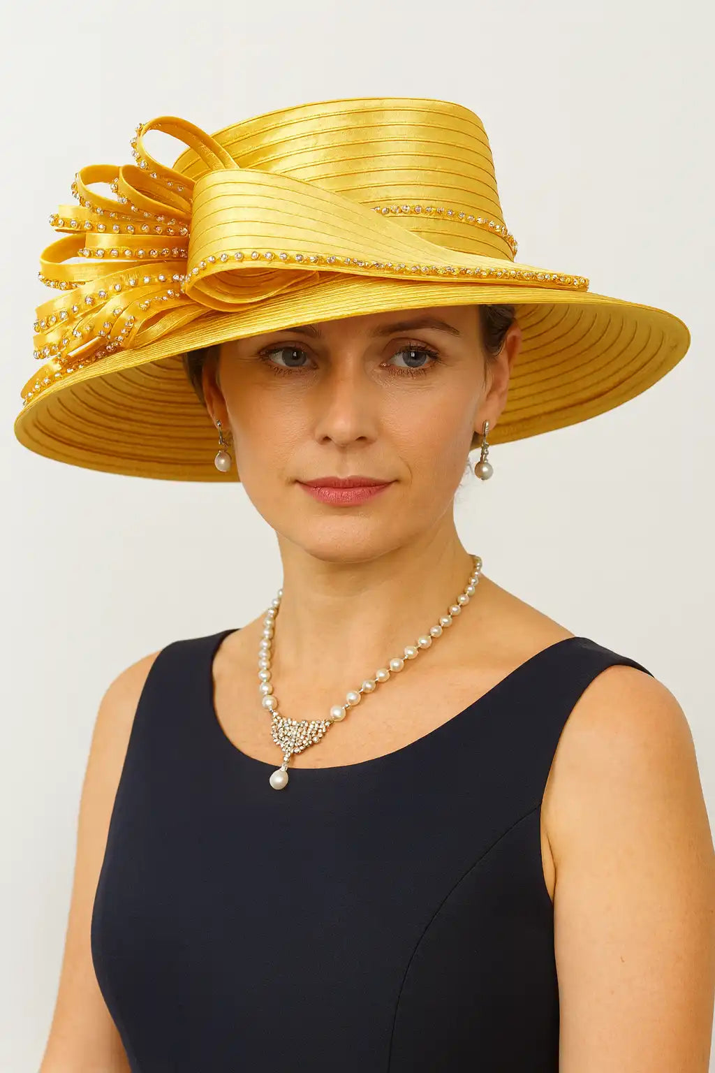 Woman wearing gold rhinestone church hat with pearl jewelry for Sunday service
