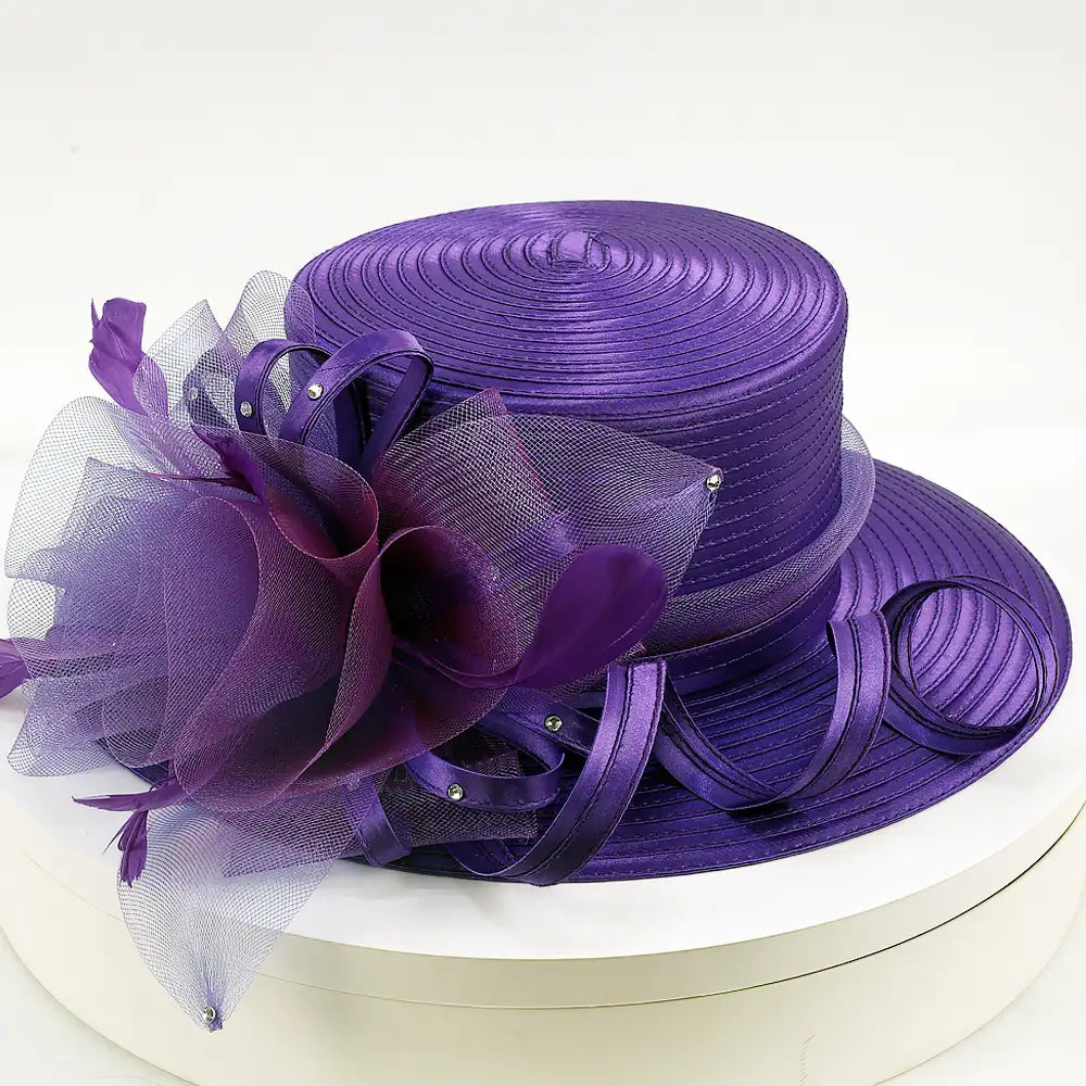 Front angle of elegant purple church hat featuring mesh floral accents and satin loops – FORBUSITE Grace in Bloom