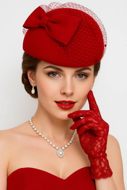 Red birdcage veil fascinator hat with bow — vintage pillbox style for women