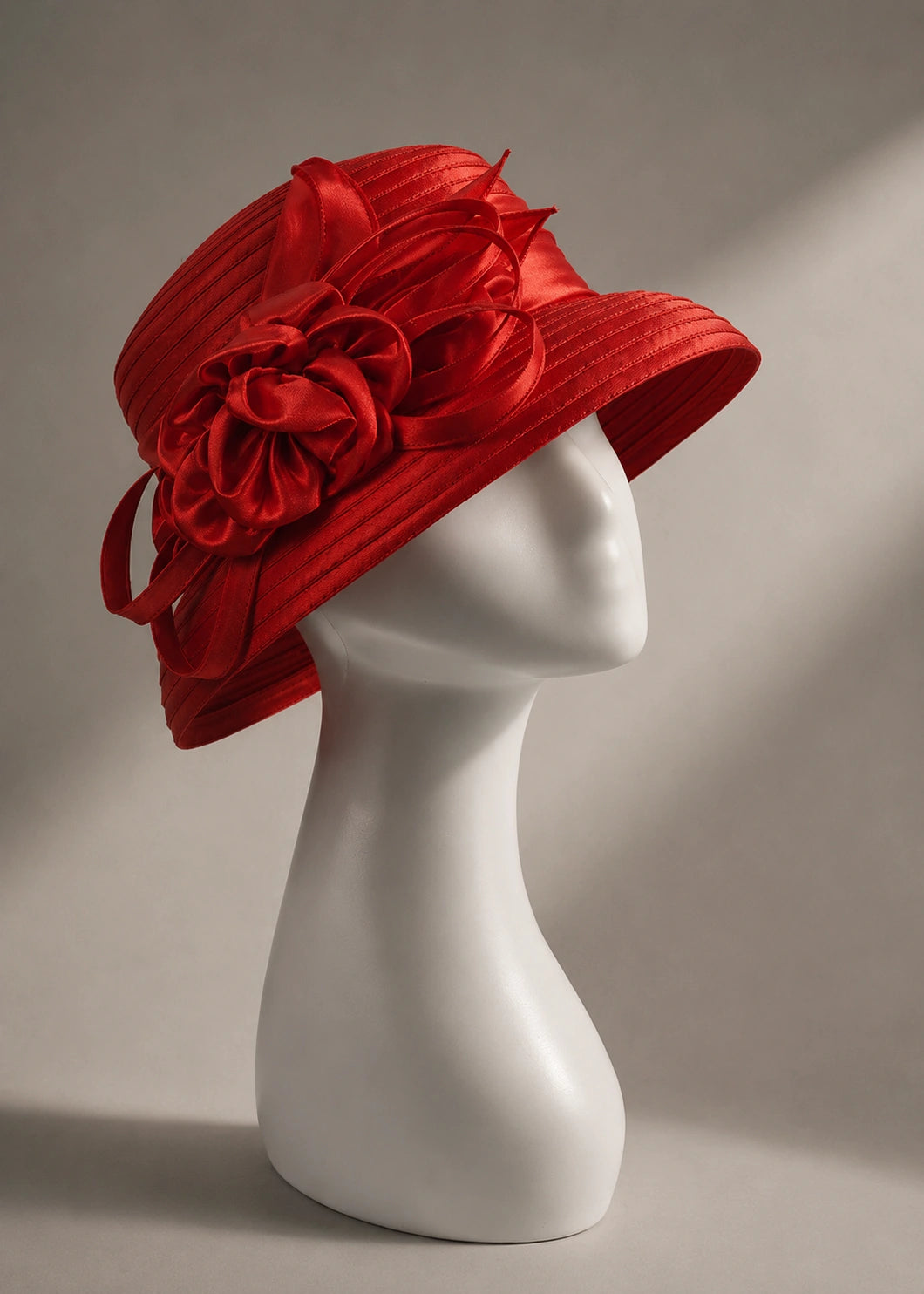 Red satin cloche church hat with short brim and floral ribbon decoration for elegant church outfits and special occasions.