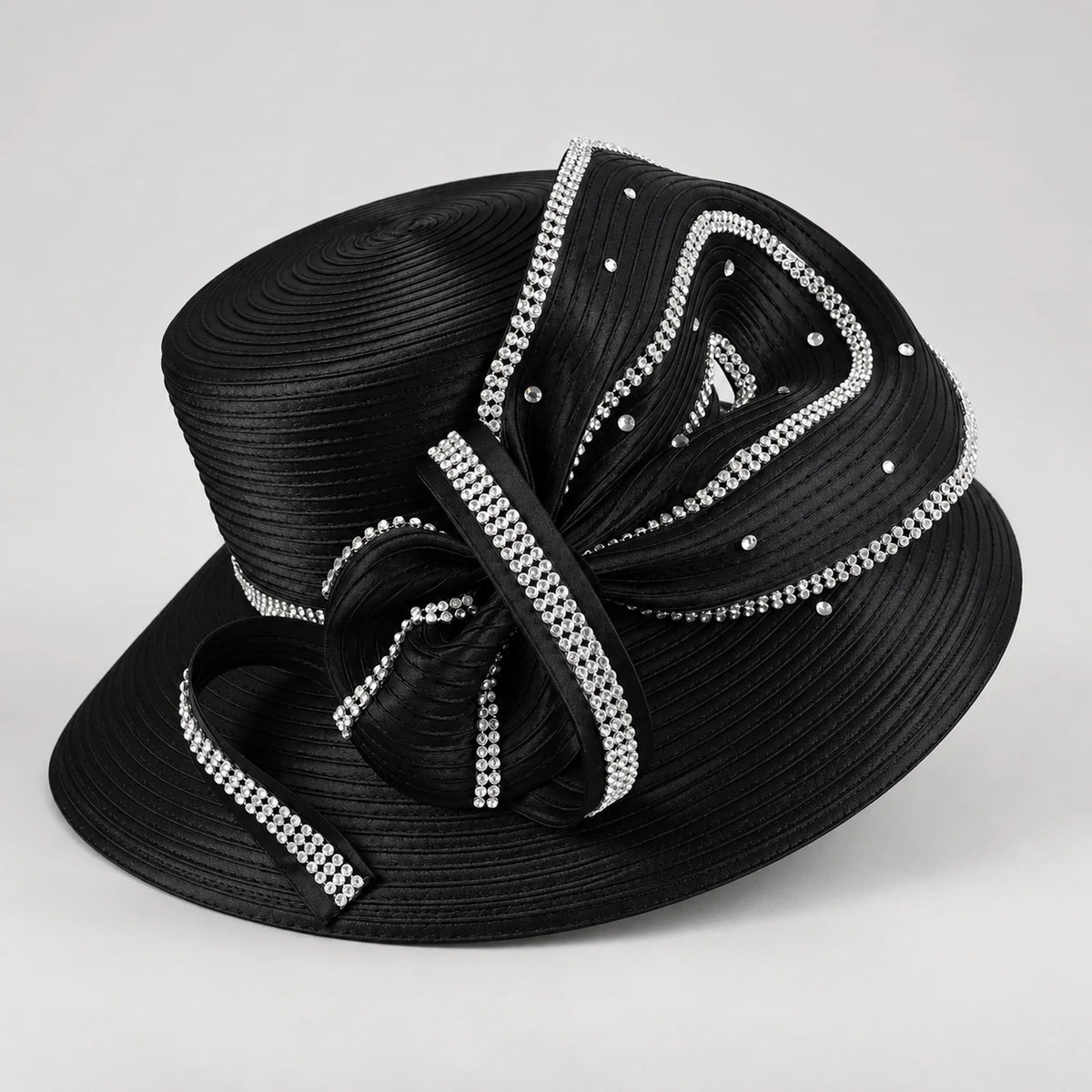 Angled view of a black church hat with layered satin ribbon loops, rhinestone accents and a wide brim