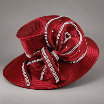 Angled view of a burgundy church hat showing the layered satin bow, rhinestone edging and structured brim
