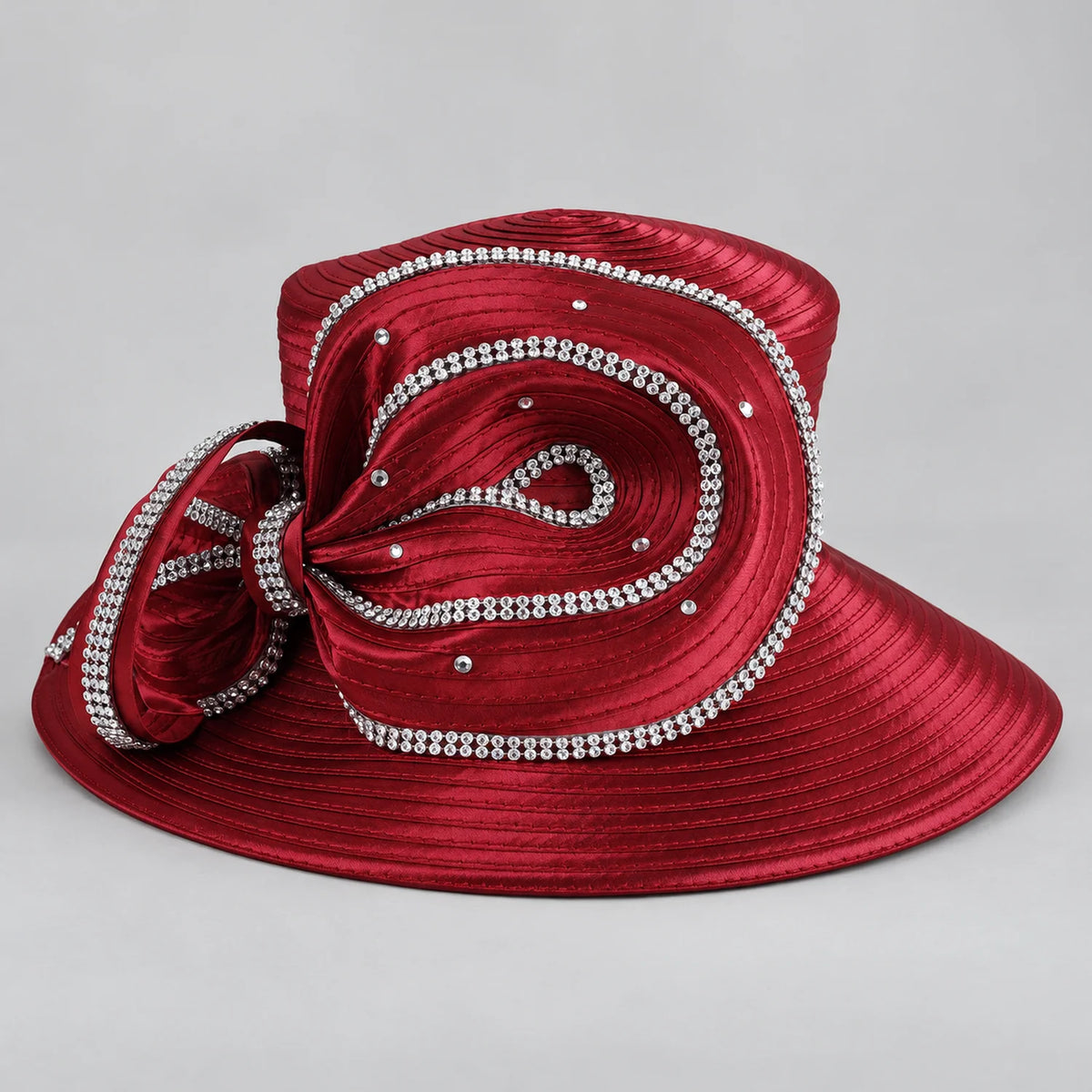 Burgundy satin church hat with a wide brim and oversized sculptural ribbon bow decorated with rhinestones