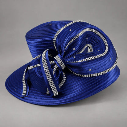 Angled view of a royal blue church hat highlighting the sculptural satin bow and rows of silver rhinestones