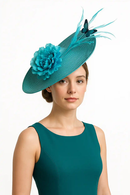 Teal blue fascinator with flower and butterfly, worn by woman in matching dress