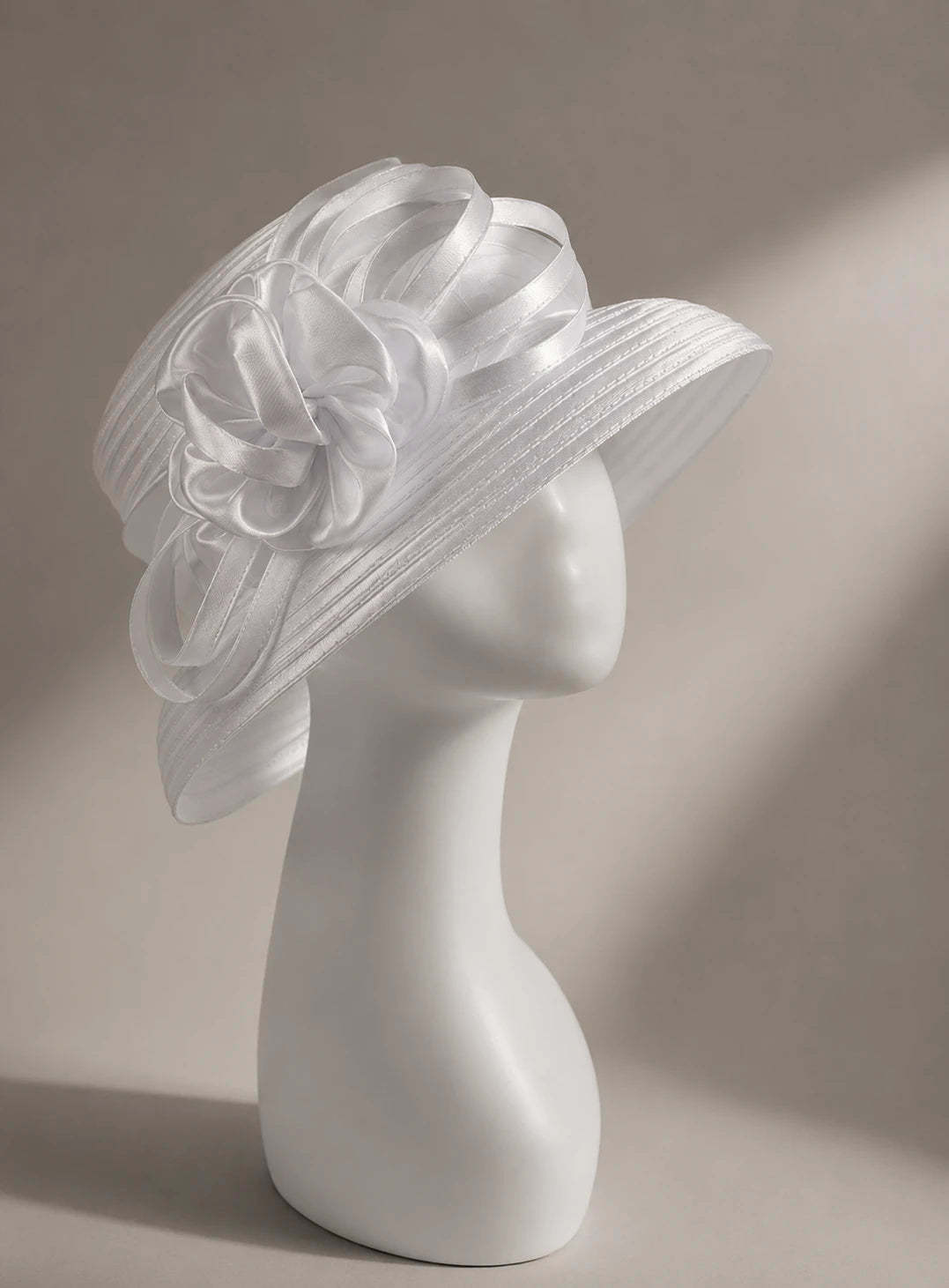 Elegant white cloche church hat with short brim and satin flower trim, perfect for Easter, weddings, and church fashion.