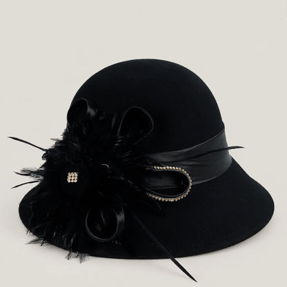 Black wool church hat with feather, ribbon and rhinestone detail, shown at a three-quarter angle