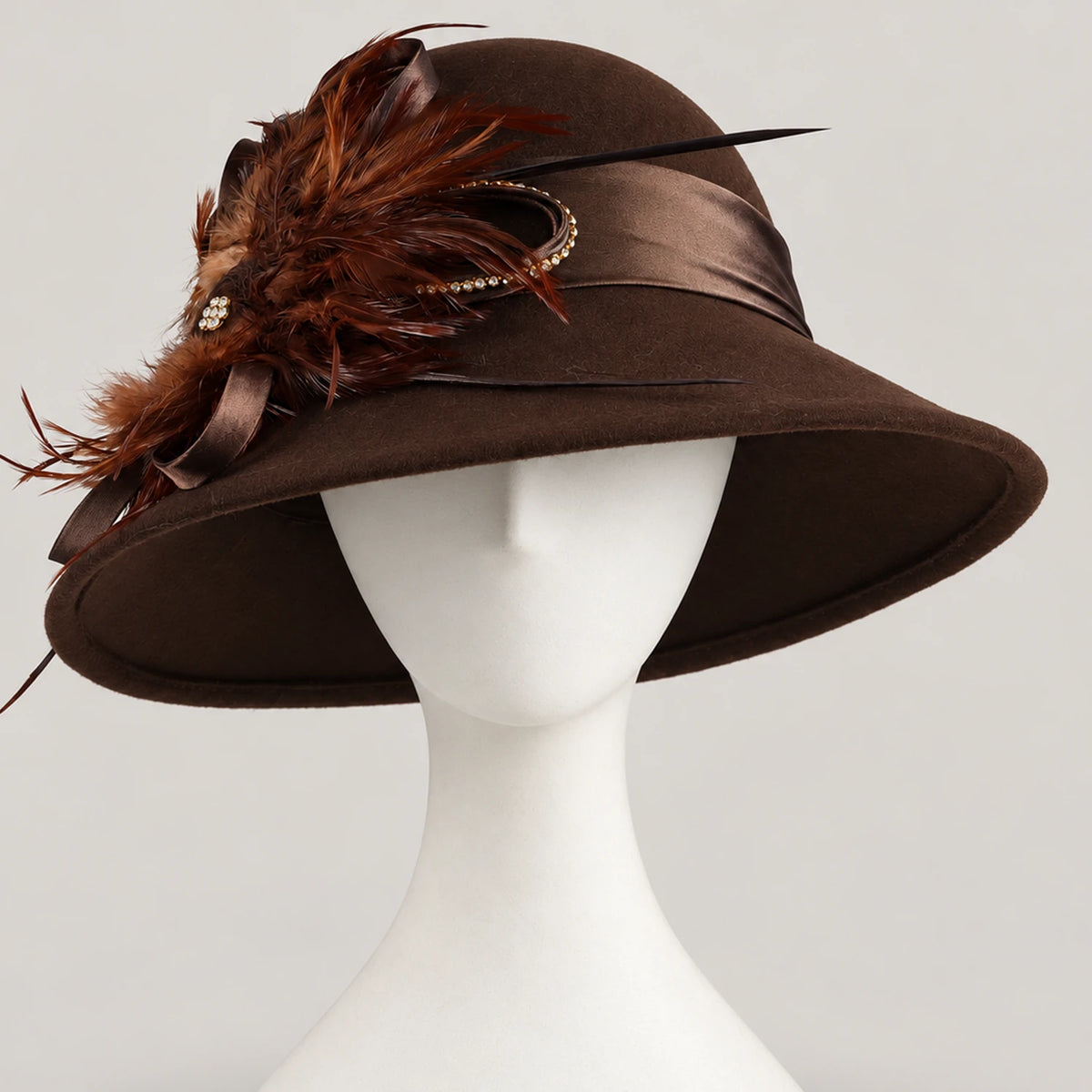 Brown feather-trimmed church hat displayed on a white mannequin