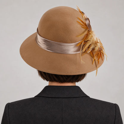 Rear view of a woman wearing the camel Z025M hat, showing the crown and ribbon band