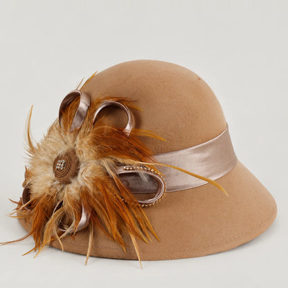 Camel wool church hat with feather, satin ribbon and rhinestone detail, shown at a three-quarter angle
