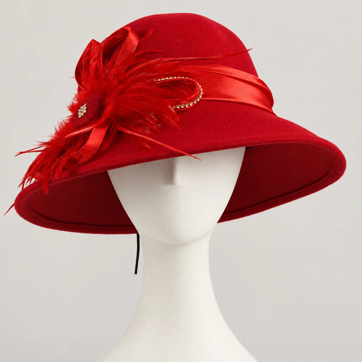 Red feather-trimmed church hat displayed on a white mannequin
