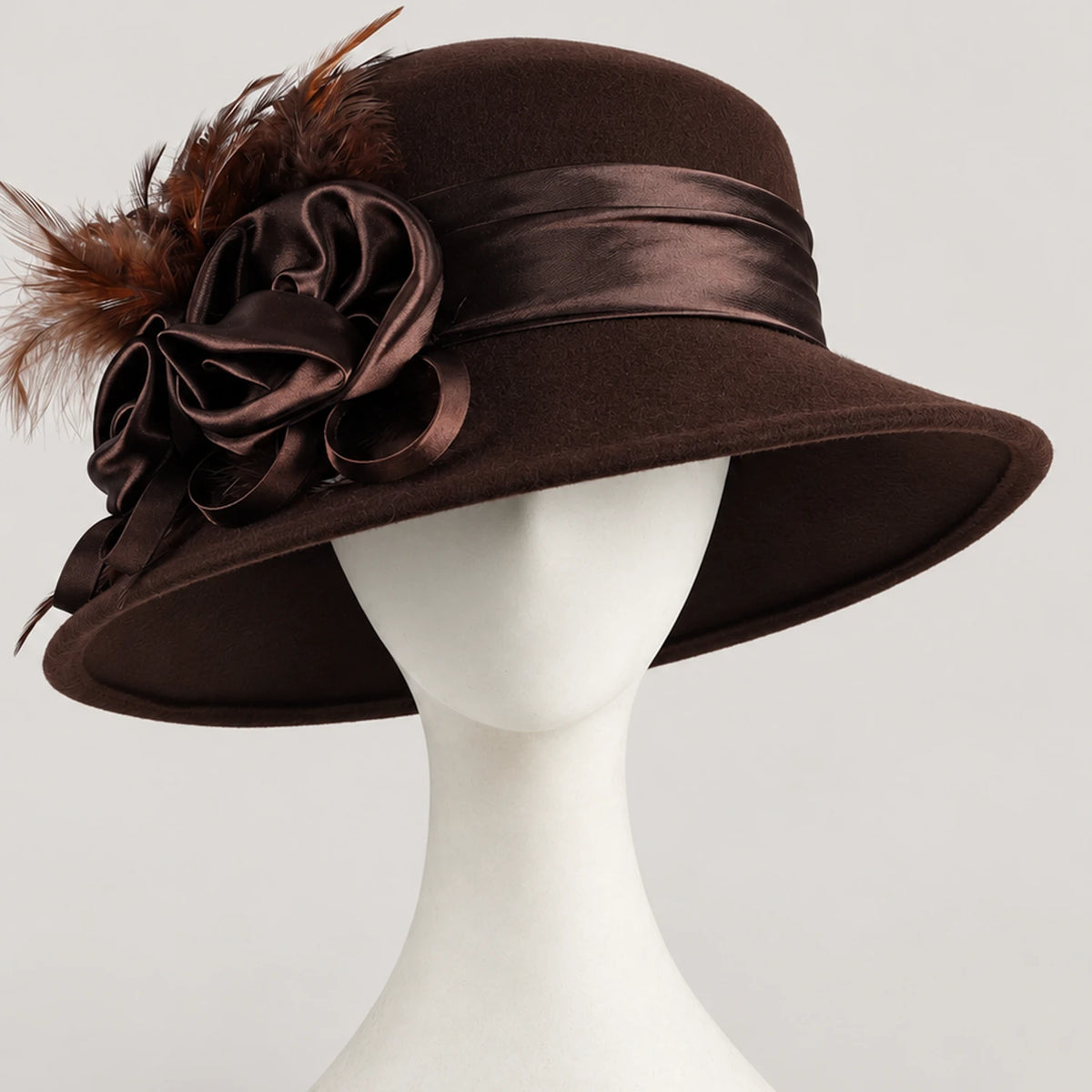 Brown Z026H wool church hat with ribbon flower and feather decoration on a white mannequin