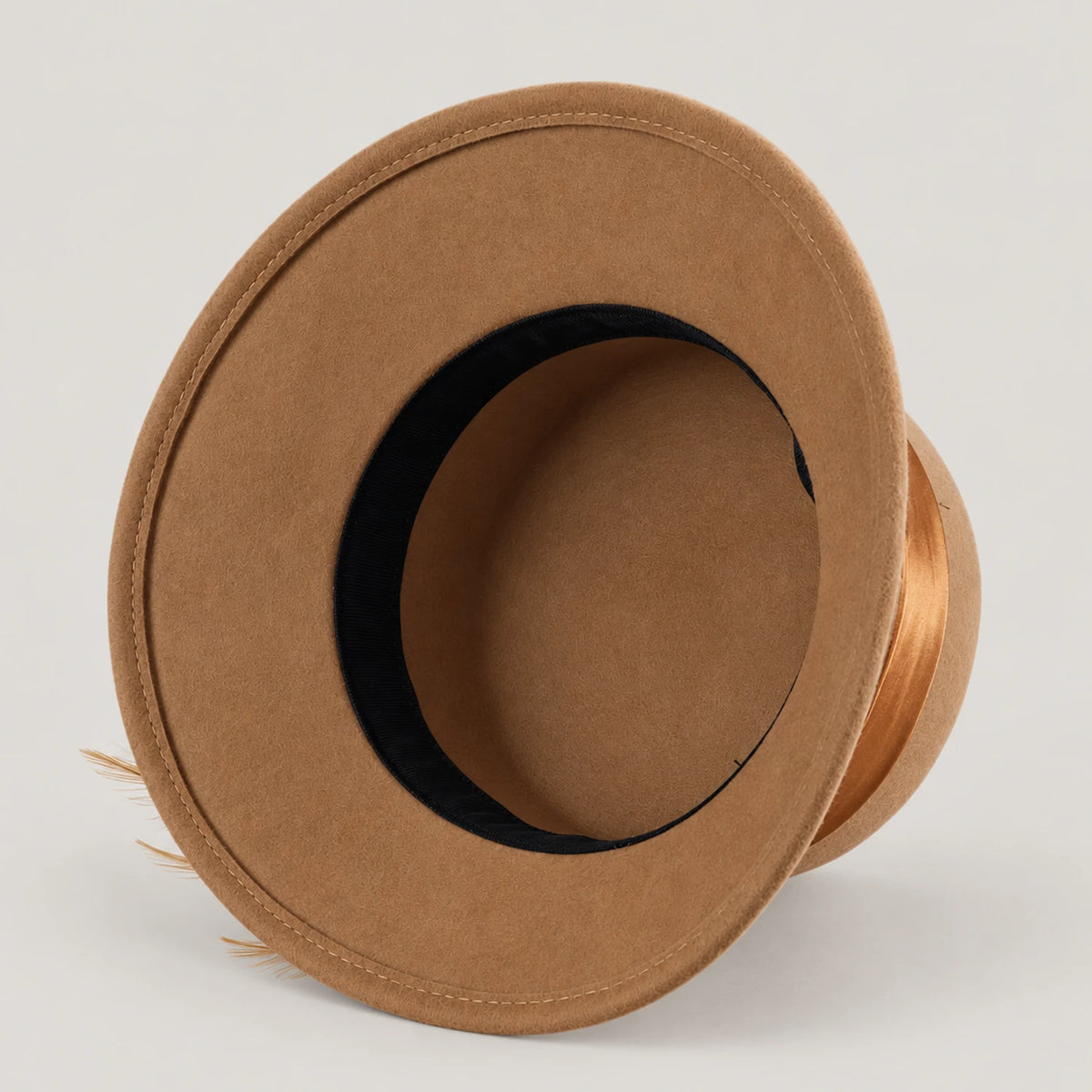 Underside of the camel Z026H hat showing the unlined wool body and black inner sweatband